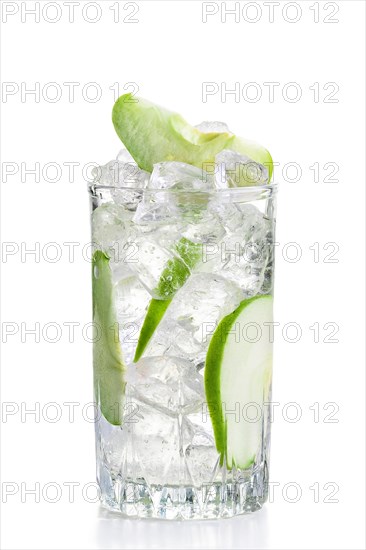 Glass of cold apple lemonade with ice isolated on white background
