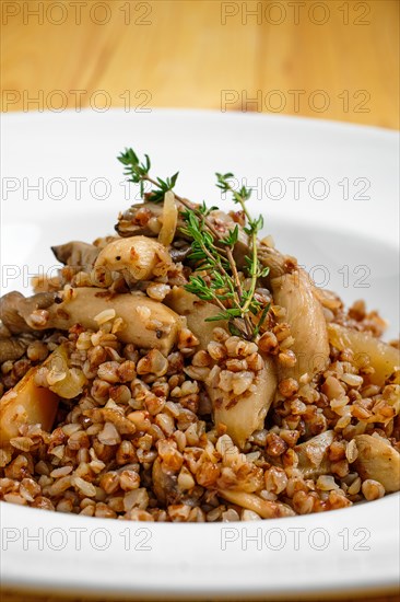 Close up view of boiled buckwheat with marinated mushrooms