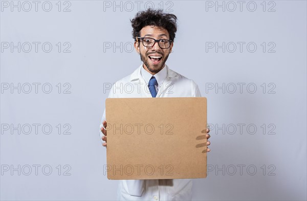 A scientist in a white coat is holding and showing a blank clipboard. Scientist showing and pointing at a blank clipboard