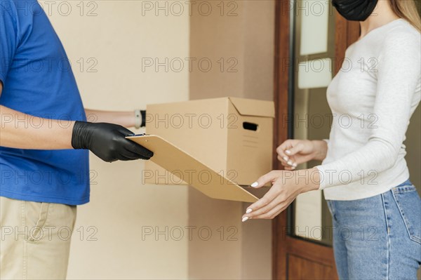 Close up delivery man giving box