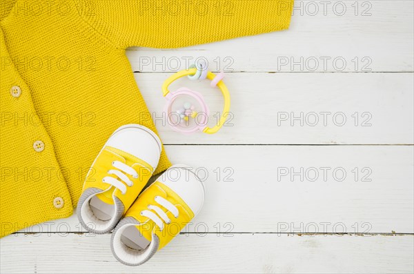 Flat lay baby clothes with wooden background
