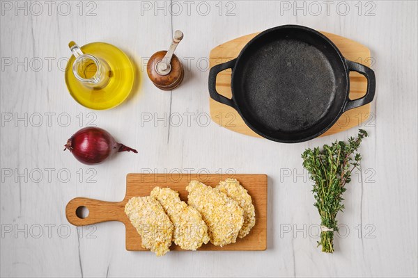 Top view of semifinished and frozen chicken nuggets in breading ready for frying