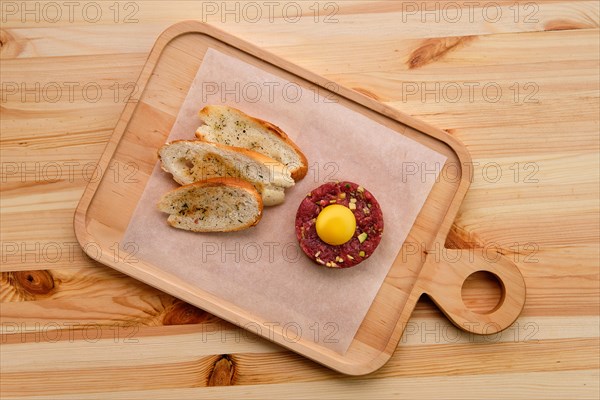 Classic steak tartare with egg and garlic bread