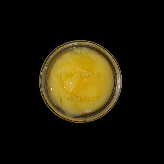 Top view of pot with honey isolated on black