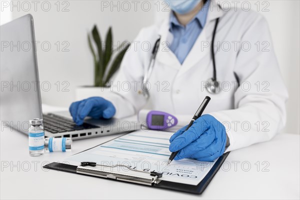 Close up doctor working laptop