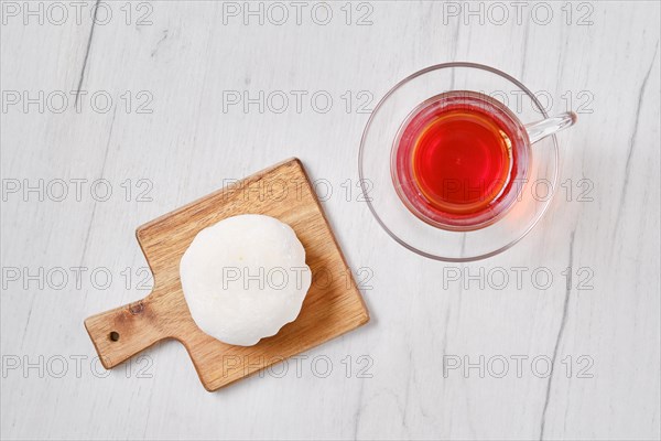 Top view of sweet dessert mochi with coconut chips with fruit tea