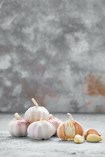 Garlic cloves and bulbs on wooden cutting board
