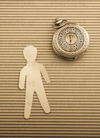 Paper man shape and a retro pocket watch