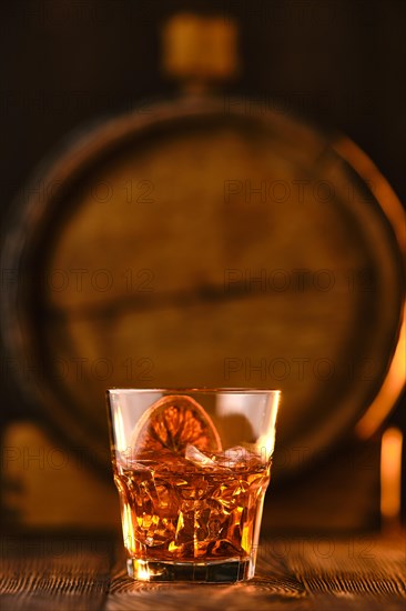 Cocktail old fashioned with barrel on background