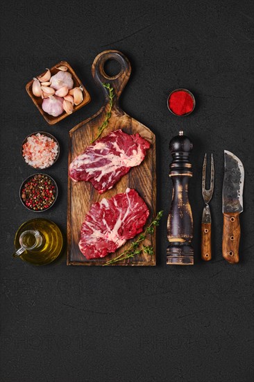 Overhead view of black table with raw fresh beef spider steak