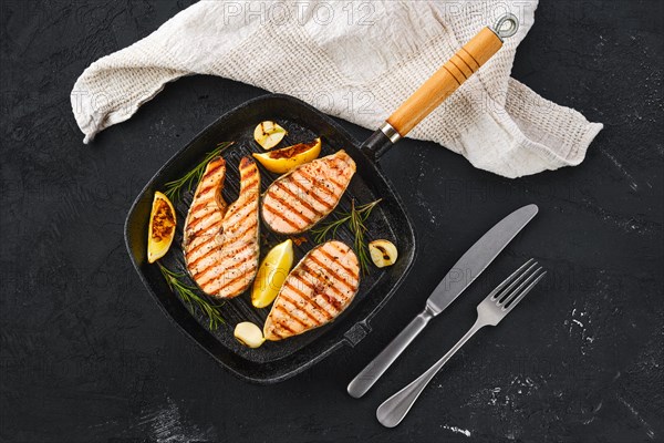 Overhead view of grilled trout steaks on pan