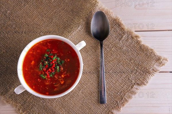 Top view of plate of gazpacho on wooden table