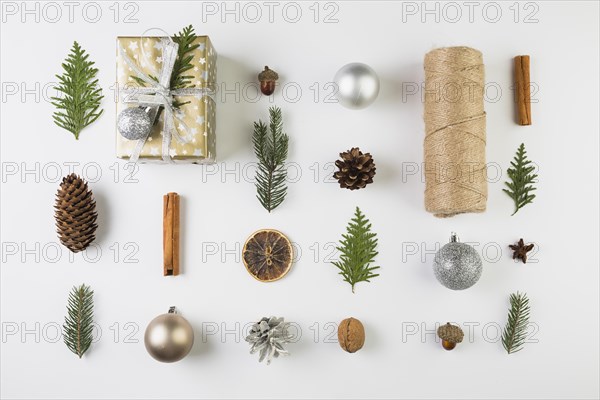 Present box near coniferous twigs snags bobbin twists ornament balls