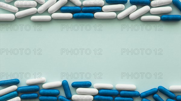 Top bottom border made with capsules candies colored backdrop. Resolution and high quality beautiful photo
