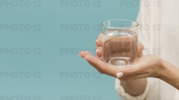 Woman holding glass filled with water copy space. Resolution and high quality beautiful photo