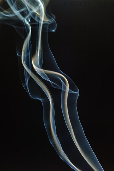 Trajectory of incense smoke in the air showing different shapes. France