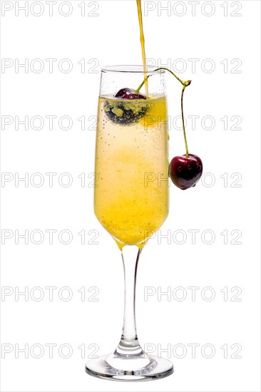 Mimosa cocktail decorated with cherry isolated on white background