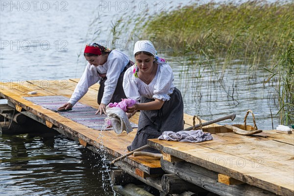 Traditionla dressed women doing hand washing