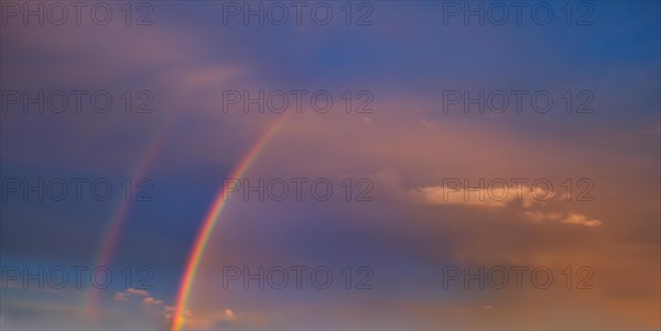 Double rainbow in an atmospheric sky with few cirrocumulus