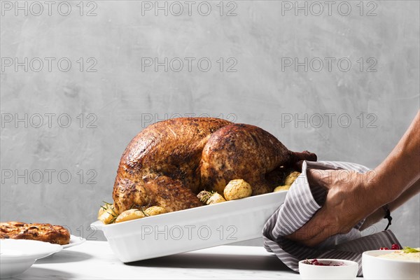 Close up hands putting turkey on table