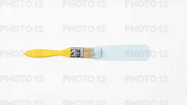 Top view yellow brush with blue paint. Resolution and high quality beautiful photo