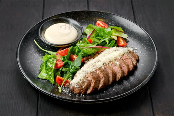 Sliced beefsteak with parmesan and fresh vegetables