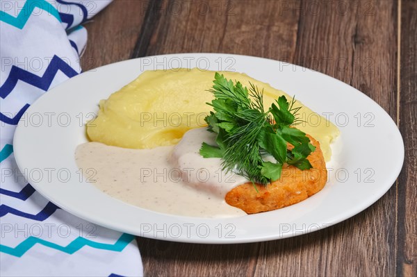Salmon cutlet and mashed potato with creamy sauce