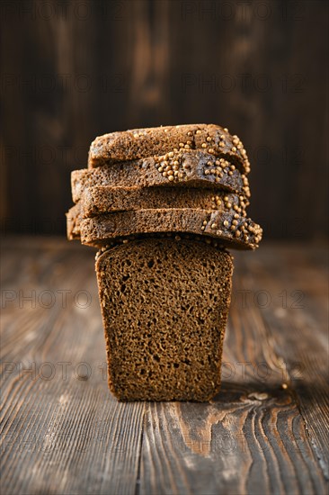 Closeup view of fresh rye brown bread on wooden cutting board