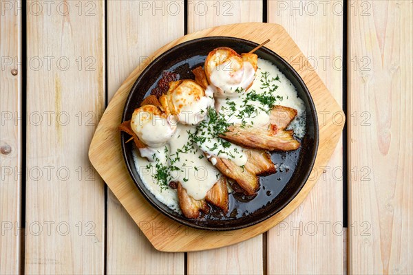 Top view of thin pancakes on skewer stuffed with cheese and served with fried bacon