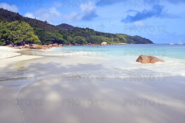 Beach and rocks of Anse Lazio in the evening