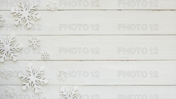 Flat lay christmas decorative snowflakes on wooden board