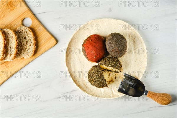 Overhead view of cottage cheese balls mixed with spice and herbs