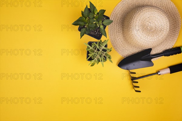 Gardening tools with straw hat copy space