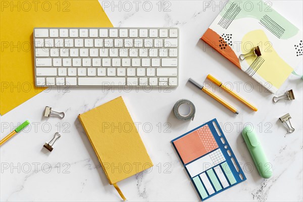 Keyboard surrounded by colorful stationery