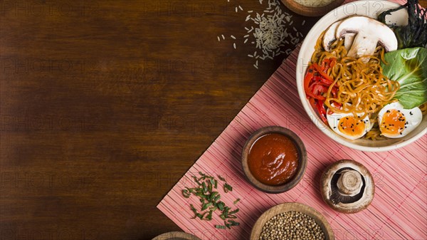 Ramen noodles asian style with sauces wooden table