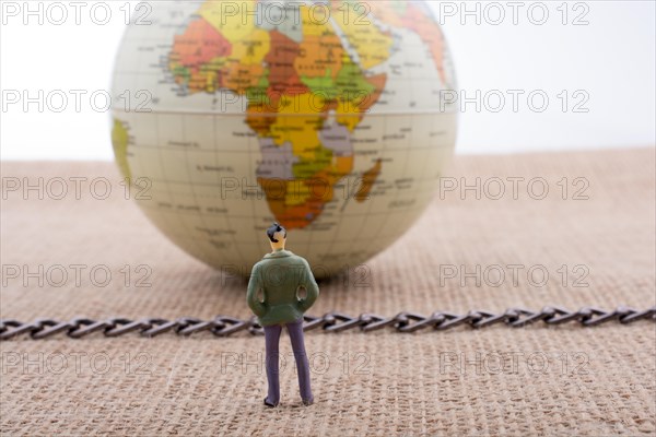 Man figurine and Globe with a chain in the middle