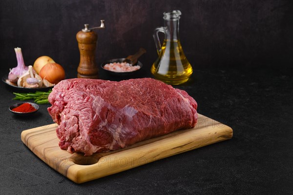 Overhead view of raw chuck eye roast with ingredients for cooking