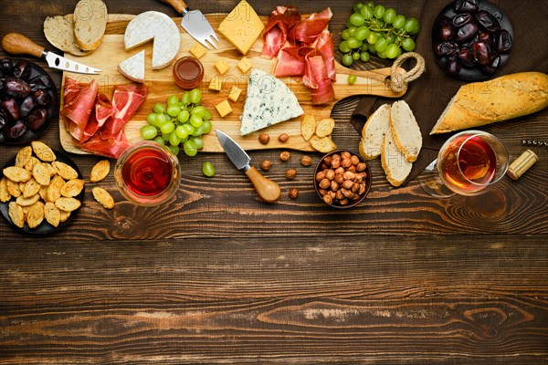 Top view of cheese plate with prosciutto