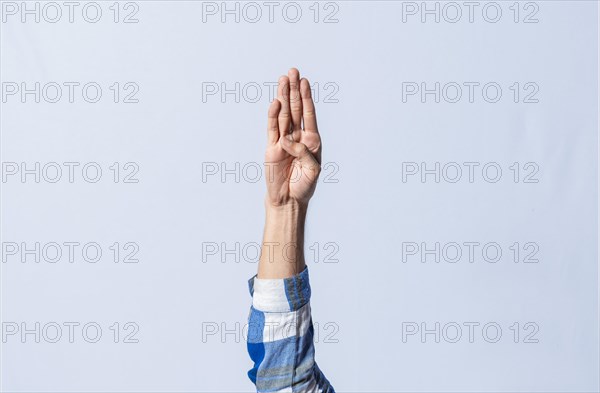 Hand gesturing the letter B in sign language on isolated background. Man hand gesturing the letter B of the alphabet isolated. Letters of the alphabet in sign language