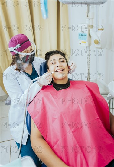 Stomatologist cleaning a patient teeth