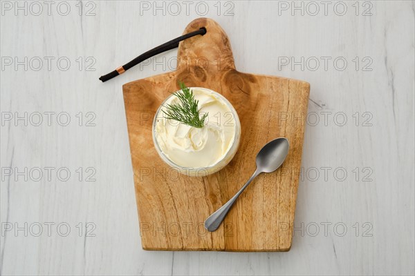 Top view of fat sour cream in a glass pot