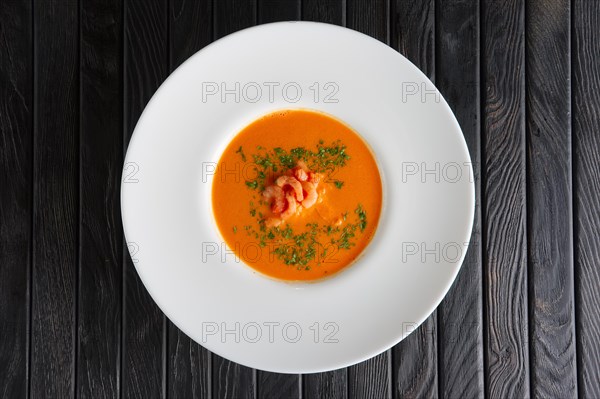 Top view of plate of soup with shrimps