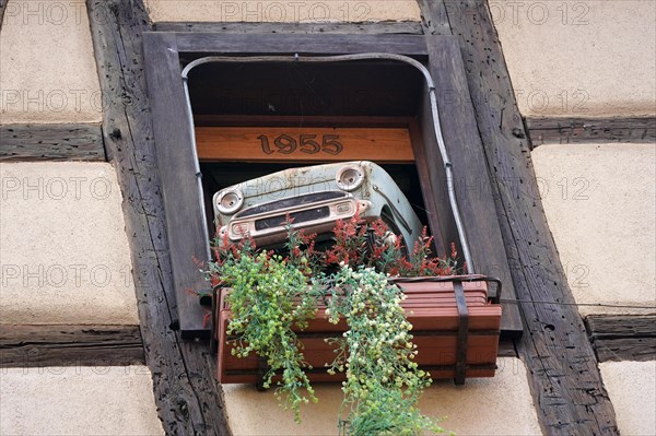 Decorated window on a half-timbered house in the historic old town of Riquewihr