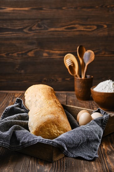 Freshly baked ciabatta on brown wooden table