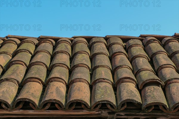 Background of old roof tiles made of colorful clay