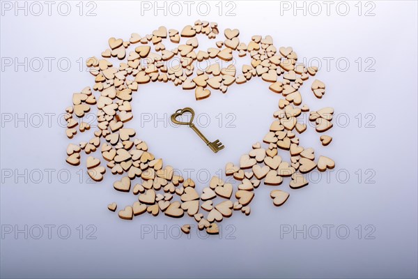 Wooden hearts form heaart shape with key as love concept