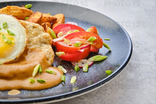 Closeup view of chopped pork sirloin with fried potato wedges
