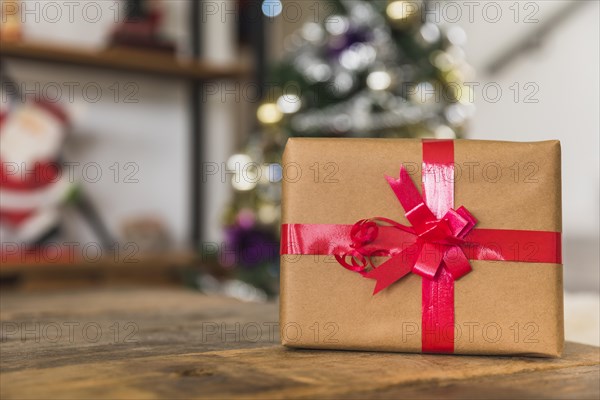 Gift box with red ribbon table