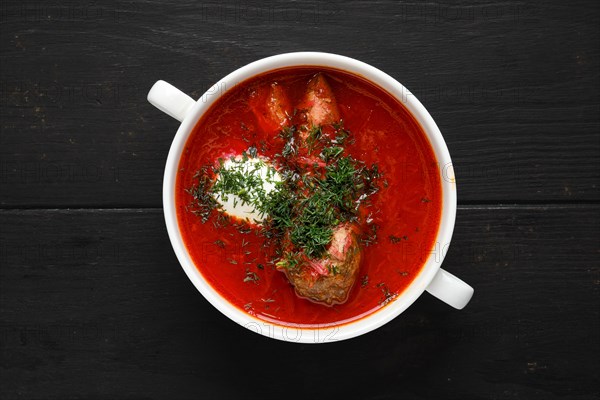 Top view of hot tomato soup with beef rib