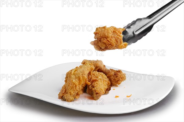 Crisp grilled chicken wings on a white dish